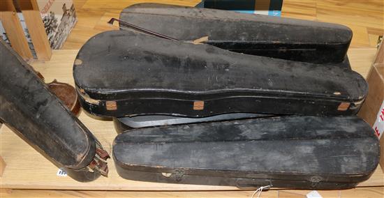 Three half size violins, a quantity of bows and six violin cases